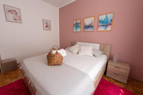 a bedroom with two beds with white sheets at APARTMAN MAKSAN in Pakoštane