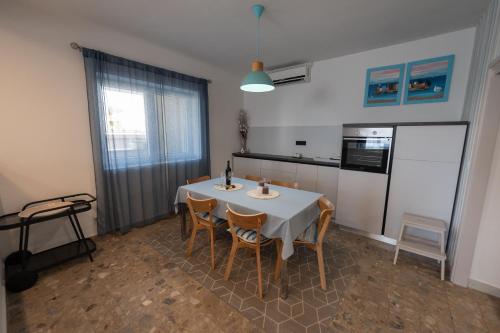 a kitchen with a table and chairs and a refrigerator at APARTMAN MAKSAN in Pakoštane