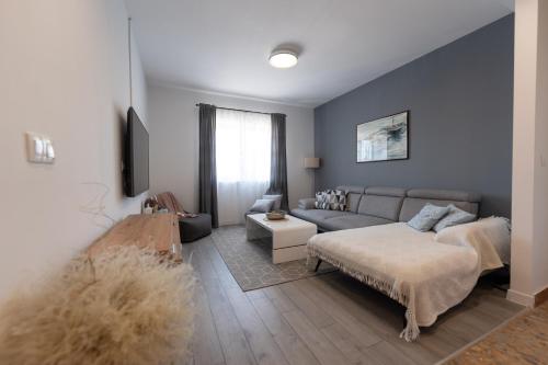 a living room with a couch and a table at APARTMAN MAKSAN in Pakoštane