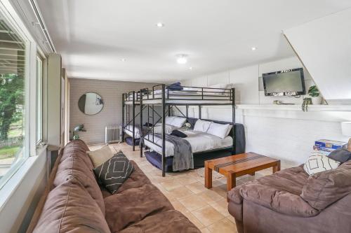a living room with a couch and a bunk bed at Dawn Retreat in Bonnie Doon
