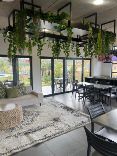 a living room with a couch and tables and chairs at Ballito Village Suites in Ballito