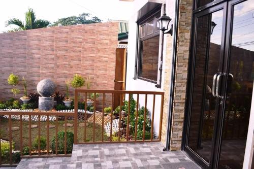an open door to a patio with a fence at Casa Del Camba Hotel and Restaurant near Hundred Islands in Alaminos