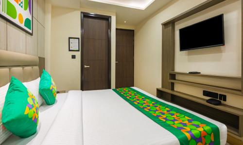 a bedroom with a bed and a flat screen tv at Treebo Bombay Palace in Chandīgarh