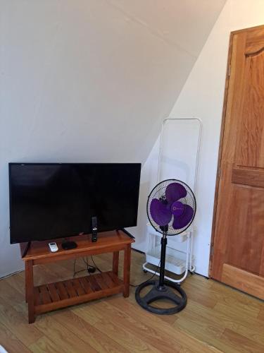 a flat screen tv sitting on top of a table at The River Cabin - Govantes Guesthouse in San Vincente