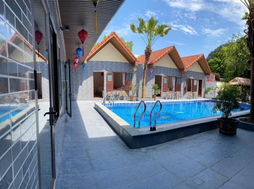 a villa with a swimming pool and a house at Tam Coc Westlake Homestay in Ninh Binh