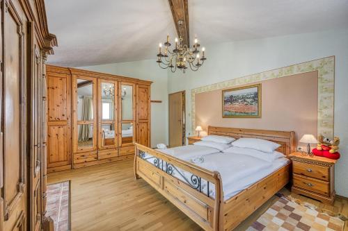 a bedroom with a large bed and a chandelier at Ivana in Karpijan in Umag