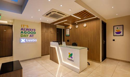 an office with a reception desk and a sign at Treebo Bombay Palace in Chandīgarh