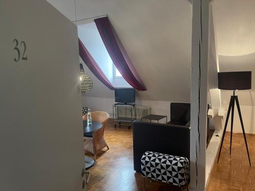 a living room with a table and a window at WHLIVING - Apartments & Studios in Konstanz in Konstanz