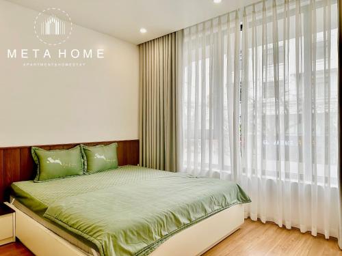 a bedroom with a bed and a large window at V-Homestay in Hai Phong
