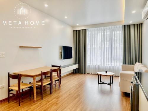 a living room with a table and chairs and a couch at V-Homestay in Hai Phong