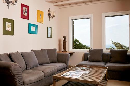 a living room with two couches and a coffee table at Diles & Rinies in Tinos Town