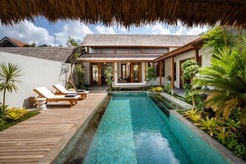a pool in the backyard of a villa at Bumbak Park Villas By Nakula in Canggu