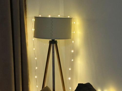 a lamp with string lights on a wall at MEDINA in Sarajevo