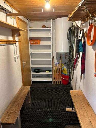 a small kitchen with a refrigerator in a small room at Chalet Glücksfall in Bellwald