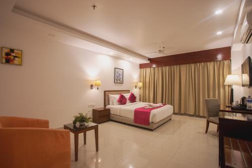 a hotel room with a bed and a couch at Diamond Palace Lords Plaza Nepalgunj in Nepālganj