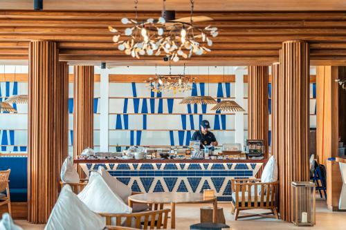 a man standing in front of a counter in a restaurant at Sichon Cabana Beach Resort in Sichon
