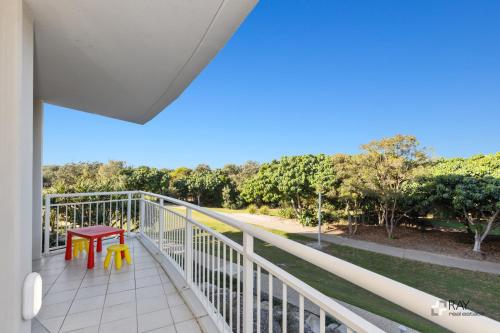 a balcony with a table and chairs on it at The Pool Resort Kingscliff - Private Apartments by Holiday Management Company in Kingscliff