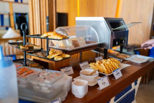 a buffet with pastries and breads on a table at Sichon Cabana Beach Resort in Sichon