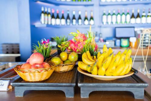 a table with baskets of fruit on a counter at Sichon Cabana Beach Resort in Sichon