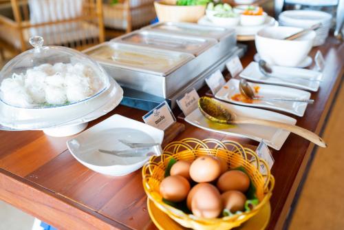 a buffet with eggs in a basket on a table at Sichon Cabana Beach Resort in Sichon