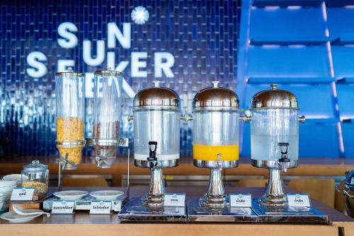 a group of three blenders sitting on a table at Sichon Cabana Beach Resort in Sichon