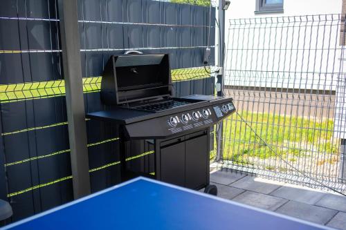 a grill with a laptop sitting on top of it at Villa Joy With Pool and Hot Tub - Happy Rentals in Sračinec
