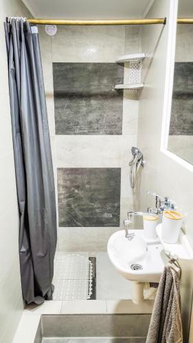 a bathroom with a sink and a shower at Apartmán Veronika in Spišský Štvrtok