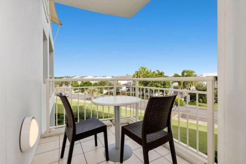 a balcony with a table and chairs and a view at The Pool Resort Kingscliff - Private Apartments by Holiday Management Company in Kingscliff