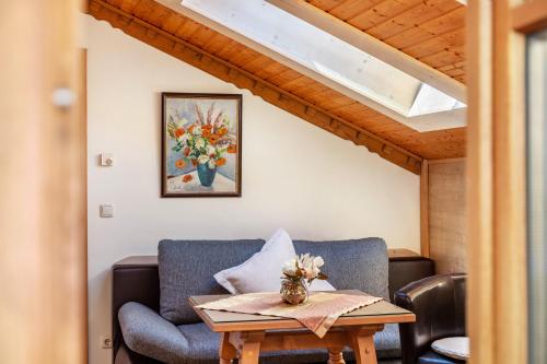 a living room with a couch and a table at Ferienhaus St Christoph in Mittenwald