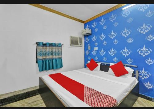 a bedroom with a bed with red pillows on it at Best hotel in Lucknow