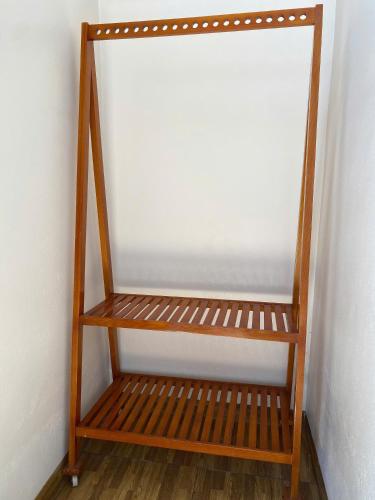a wooden shelf in a corner of a room at Tam Coc Westlake Homestay in Ninh Binh