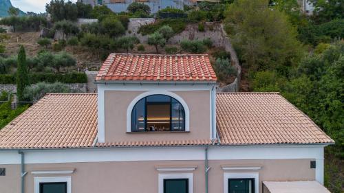 a building with a window and a roof at Kemì Luxury Suites in Vietri sul Mare