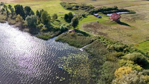 an aerial view of a house and a river at Domek Apartament Windyki in Iława