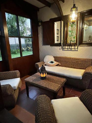 a living room with couches and a table and windows at Onar in Olympiaki Akti