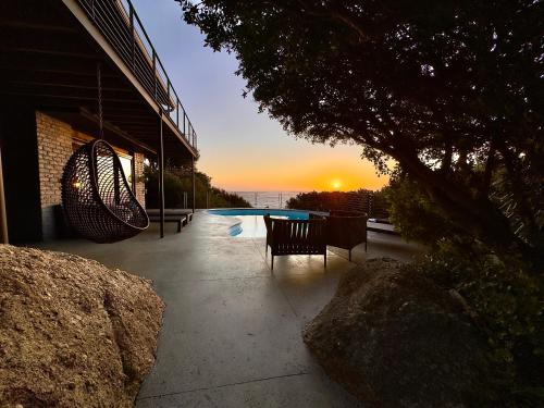 a sunset over a swimming pool in a building at The Gekko Lodge in Cape Town