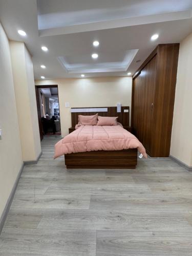 a bedroom with a bed with a pink blanket at Goit Bhawan in Nougām