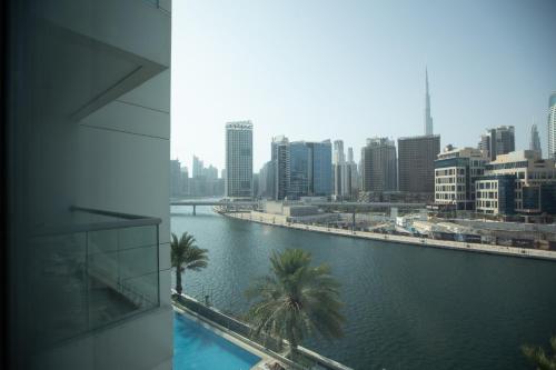 a view of a city with a body of water at Noma Fairview - Burj Khalifa view stunning apartment in Business Bay in Dubai