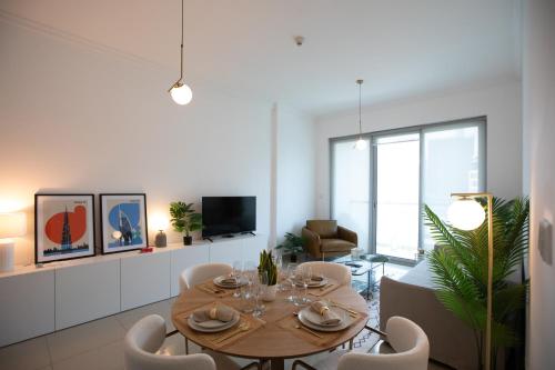 a dining room with a table and chairs at Noma Fairview - Burj Khalifa view stunning apartment in Business Bay in Dubai