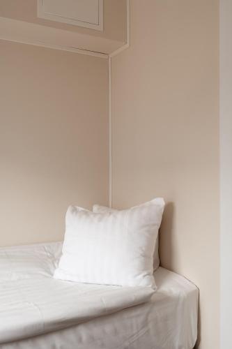 a white bed with a pillow on top of it at Smart Hotels in Säve