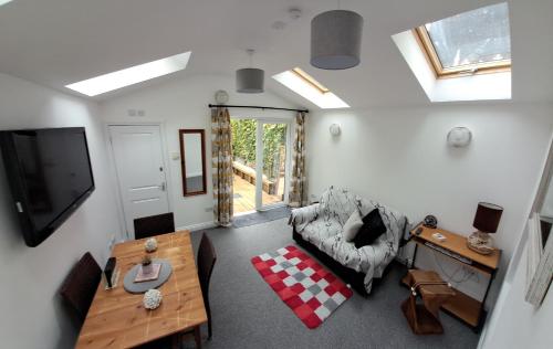 a living room with a couch and a tv at Charming Lincoln Cottage Family & Pet-Friendly in Lincoln
