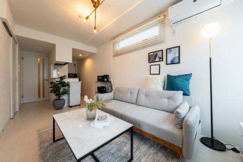 a living room with a couch and a table at Utopia in Sapporo