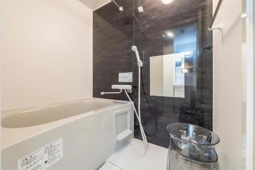 a bathroom with a bath tub and a shower at Utopia in Sapporo