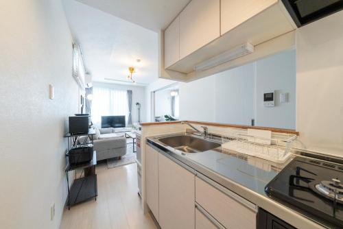 a kitchen with a sink and a counter top at Utopia in Sapporo