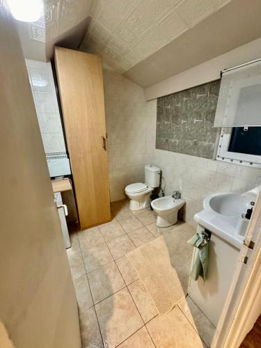 a bathroom with a sink and a toilet in it at Royal Casino Namur Balcony in Namur