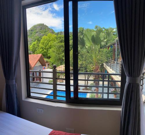 a room with a window with a view of a pool at Tam Coc Westlake Homestay in Ninh Binh