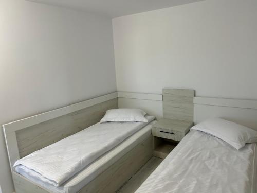 two beds sitting next to each other in a room at Pensiunea La Cazemata Bucov in Satu Bucovei