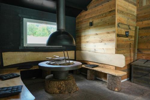 a room with a stove and a table and a window at Chalet Les Prés Chaussottes in Gérardmer