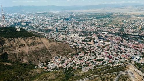 an aerial view of a city on a mountain at Solridge Aparthotel in Tbilisi City