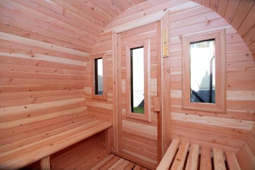 a wooden sauna with two windows in it at SPA Hotel Olymp in Velingrad