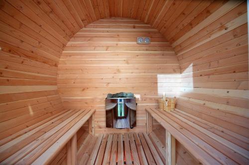 an inside of a wooden sauna with two benches at SPA Hotel Olymp in Velingrad